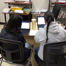 One student and One tutor sitting at laptops
