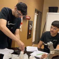 Two male students working on science lab