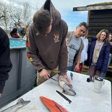 Student preparing the salmon as part of their Foods course