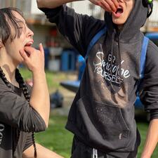 Two students eating raw salmon eggs
